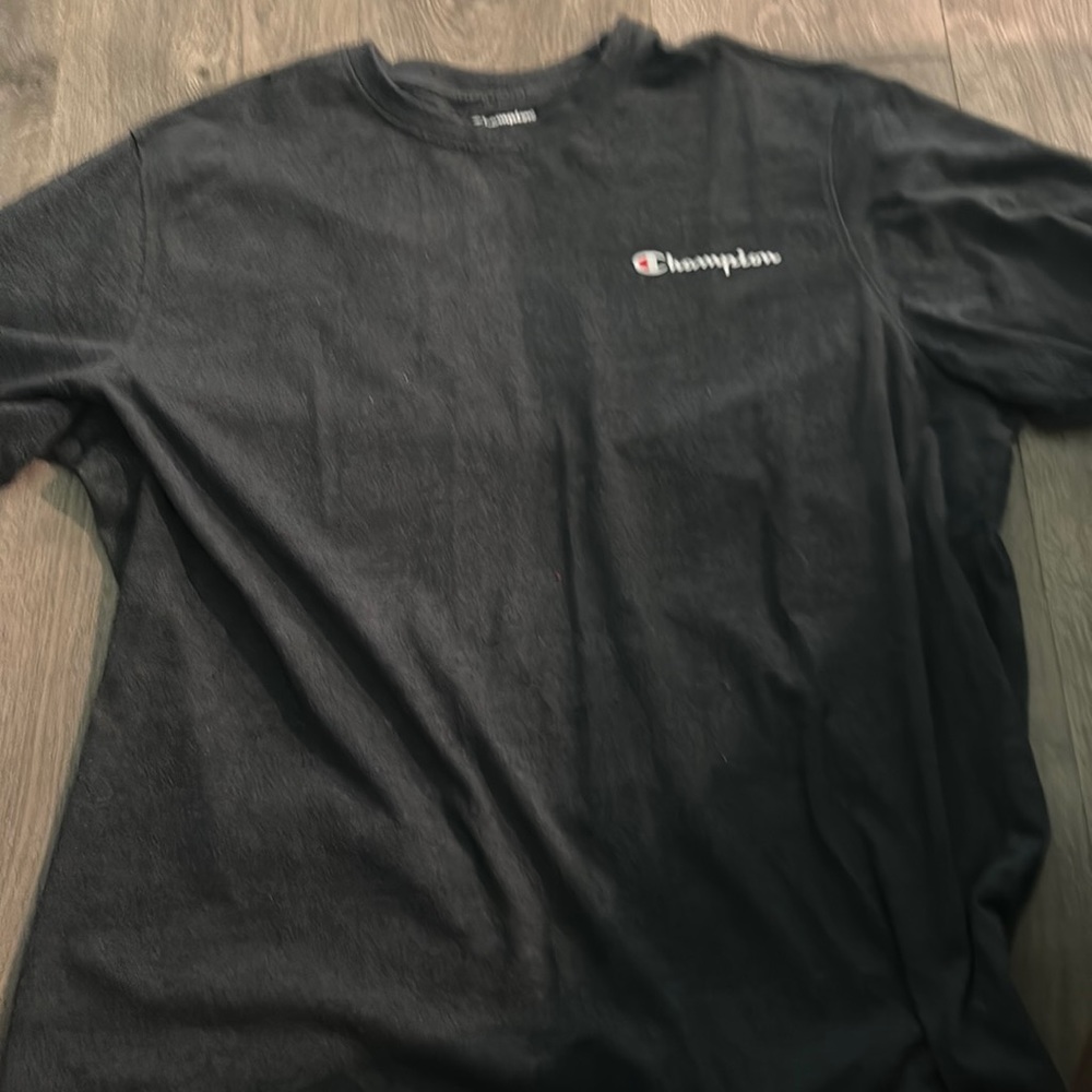 A champion tee shirt with the word champion written on the front of the shirt